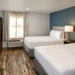 Woodspring Suites Juegos de muebles de madera para habitaciones de hotel Muebles modernos para habitaciones de hotel con tapicería