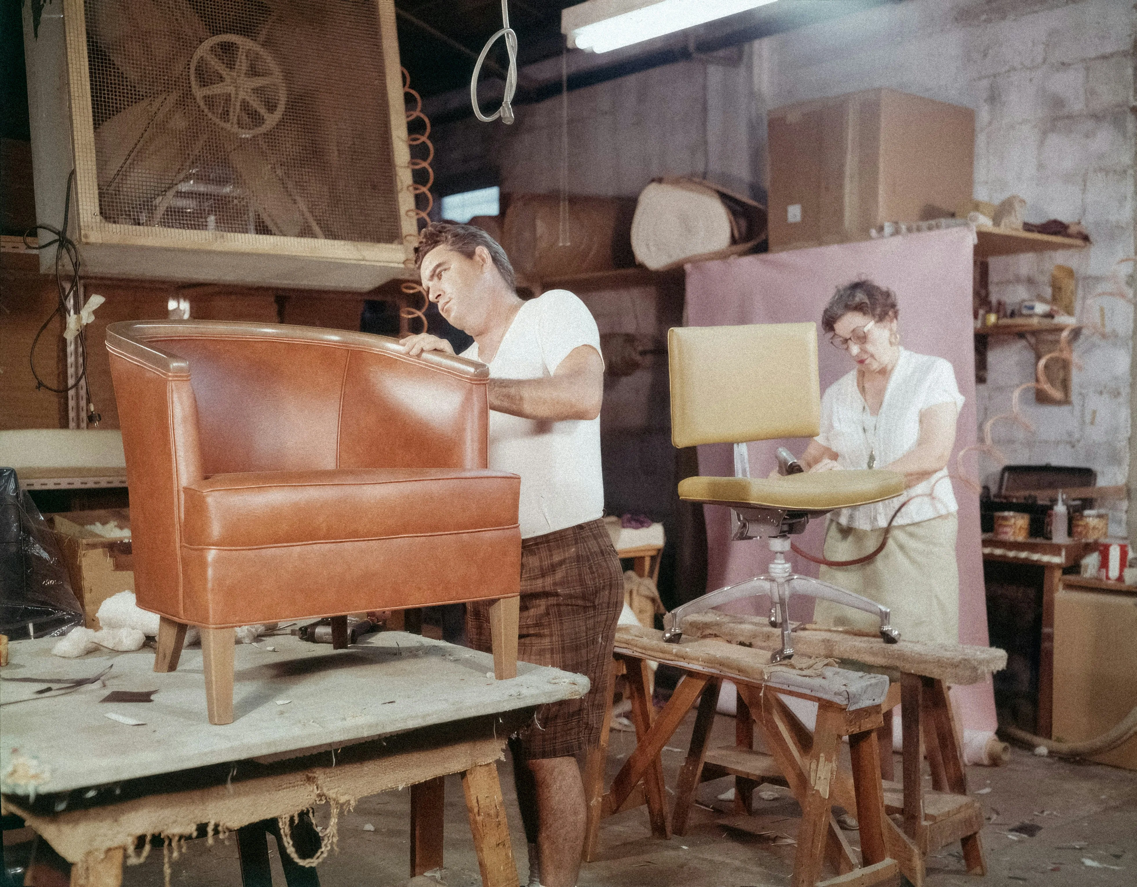 Image of hotel furniture being crafted in a factory setting with skilled workers
